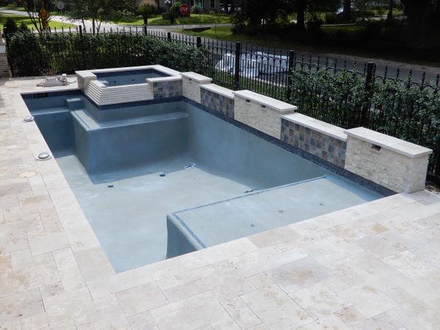 an empty pool with spa and retaining wall the concept to Upgrade Your Swimming Pool