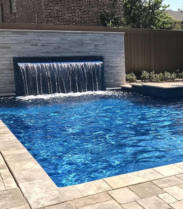 pool, stone wall with waterfall by Beaumont TX pool builder